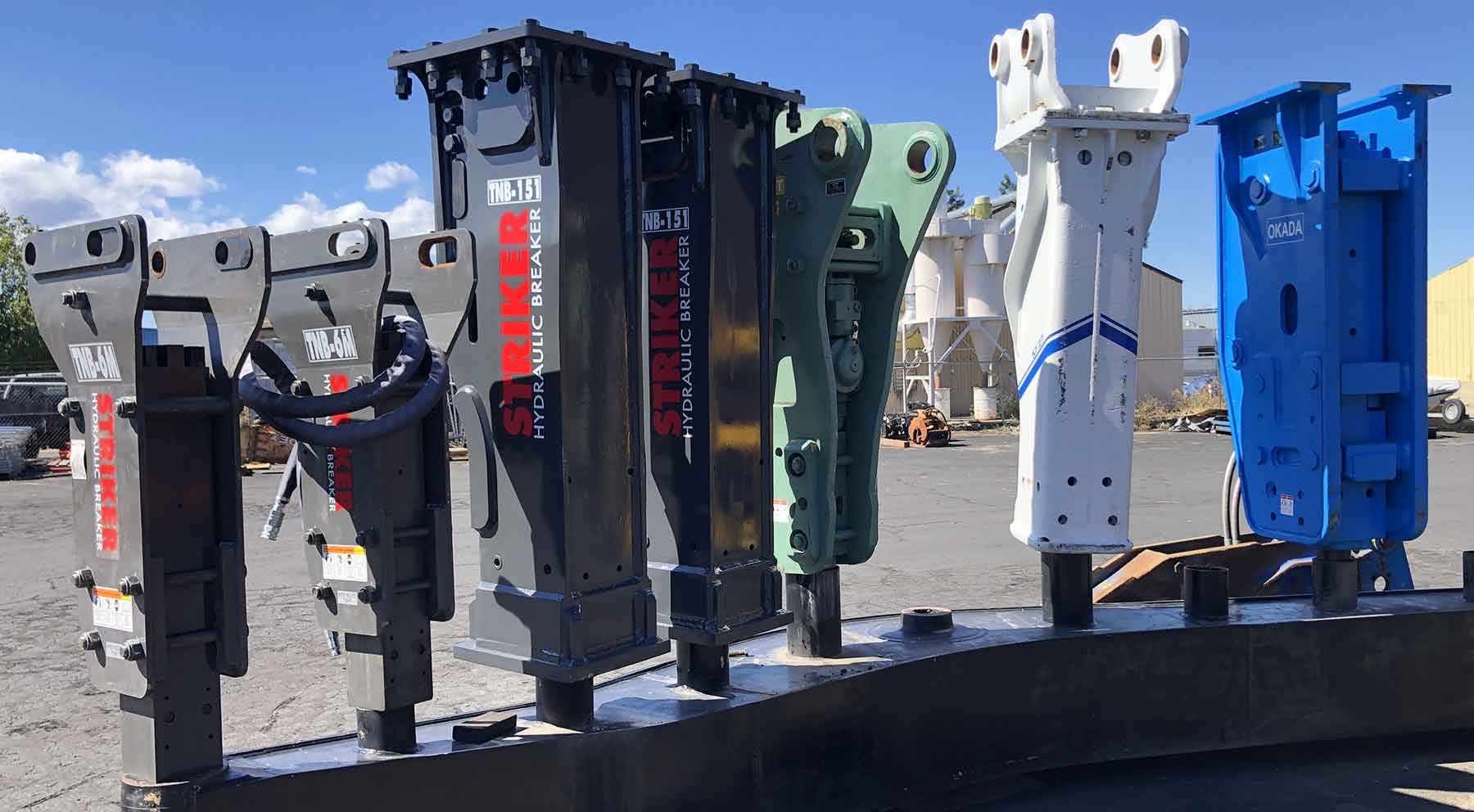 Lineup of hydraulic rock hammers for sale at Attachment Service Centers